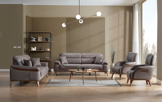 Modern living room with a gray sofa set, armchairs, wooden coffee table, and large sunlit windows.